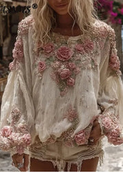 Woman wearing a floral embroidered blouse with a blurred outdoor background