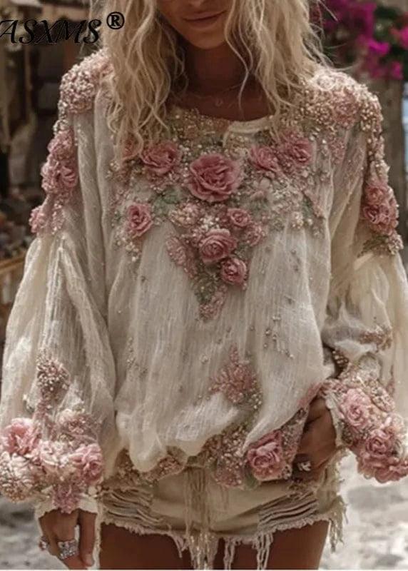 Woman wearing a floral embroidered blouse with a blurred outdoor background