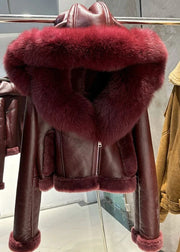 Brown leather jacket with red fur collar on a rack in a store