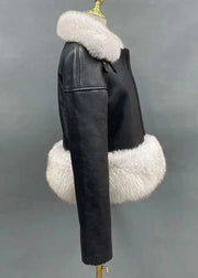 Black leather jacket with white fur trim on a mannequin against a gray background