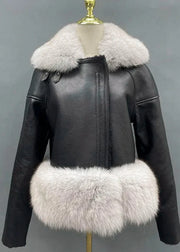 Black leather jacket with white fur trim on a mannequin against a gray background