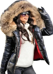 Woman wearing a black leather jacket with a fur-lined hood on a white background