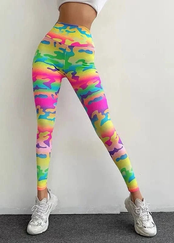 Colorful camouflage leggings worn by a person against a white background