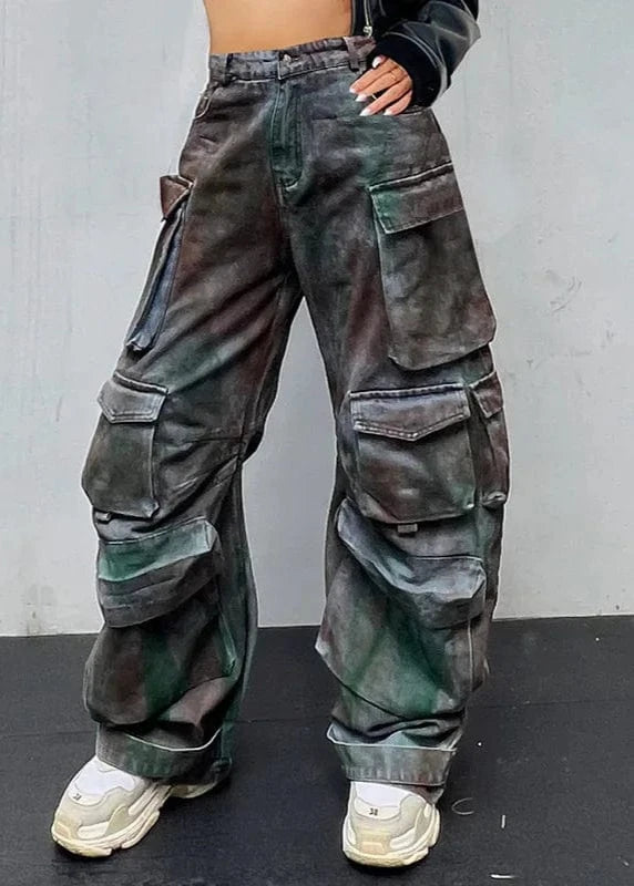 Person wearing camouflage cargo pants against a plain background