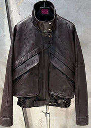 Brown leather jacket on a mannequin against a concrete wall.