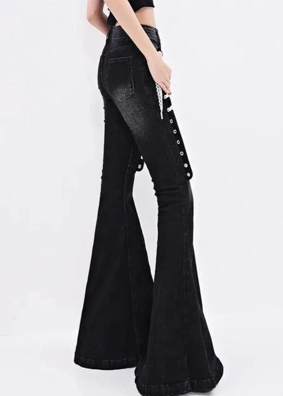 Black flared jeans with button details on a white background