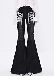 Black bell-bottom jeans with lace-up details on a white background
