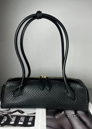 Black textured handbag on a light gray background