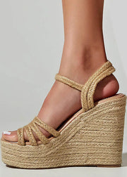 Beige wedge sandal with rope detailing on a neutral background