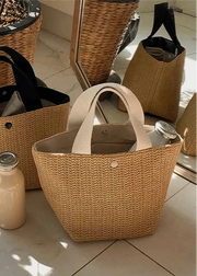Woven bags on a tiled floor with a jar of milk and a bottle.
