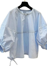 Light blue blouse with balloon sleeves on a hanger against a white background