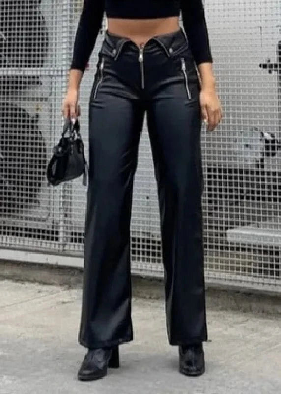 Person wearing black high-waisted pants and black top in an urban setting