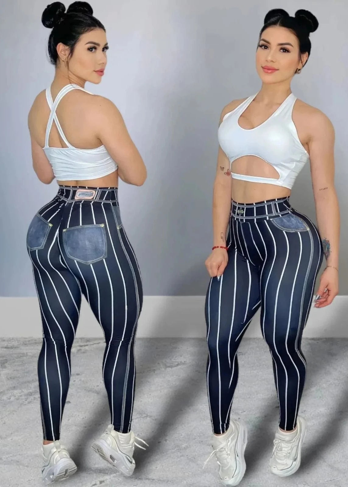 Woman wearing a white sports bra and blue striped leggings posing against a gray background.