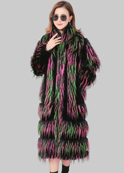 Woman wearing a long, patterned coat with a brand logo in the corner.