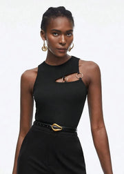 Woman wearing a black dress with gold accents on a white background