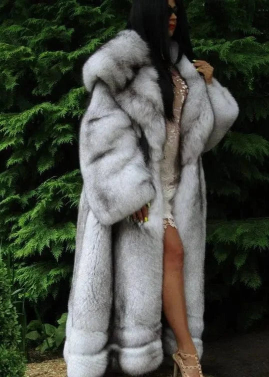 Person wearing a fur coat with a green foliage background