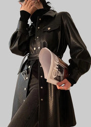 Person wearing a black textured coat holding a magazine with 'Lautaro' brand visible.