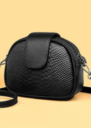Black textured handbag on a beige background