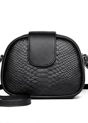 Black textured handbag with a strap on a white background