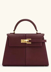 Maroon handbag with gold hardware on a white background