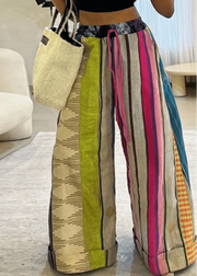 Colorful striped pants worn by a person in a casual setting.