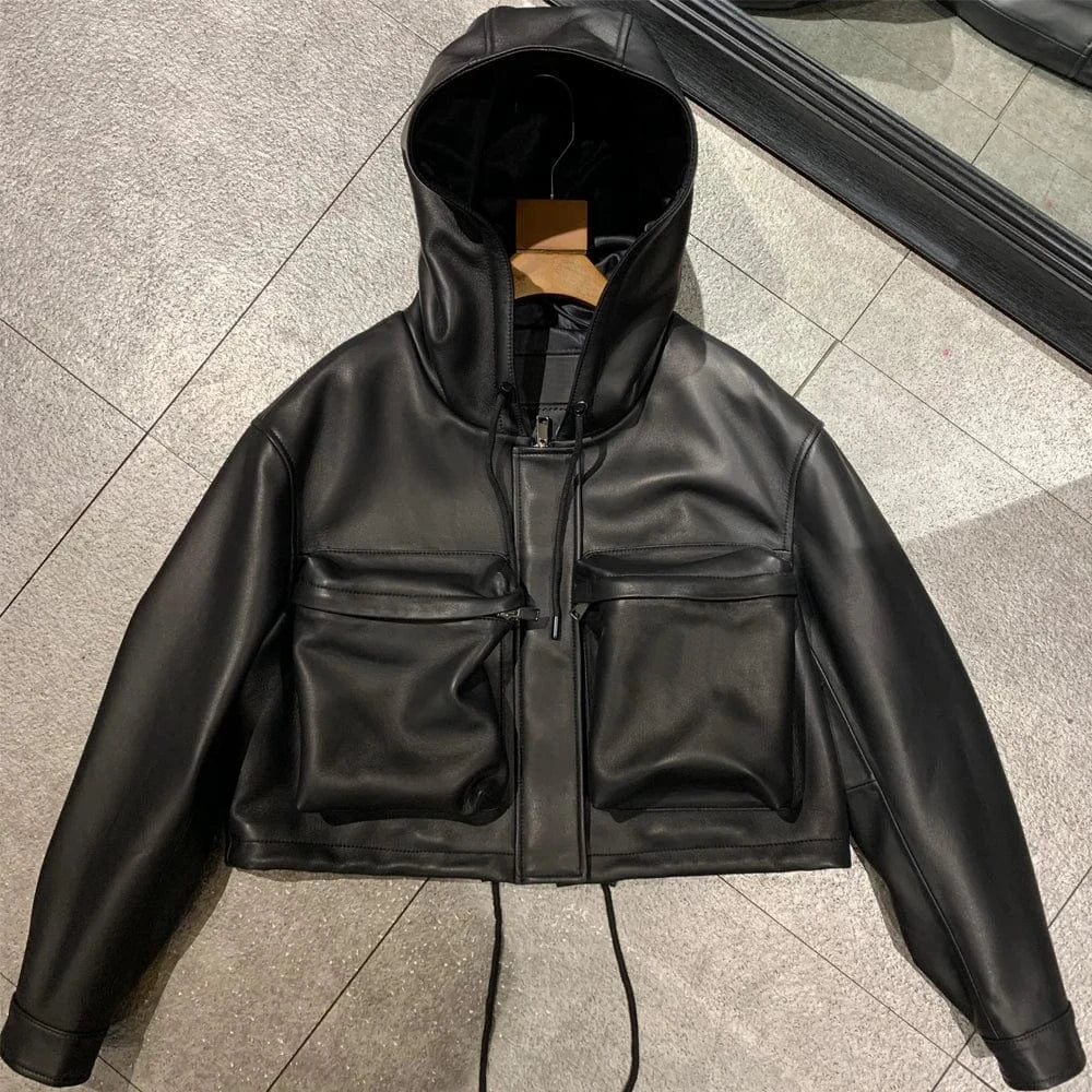Black leather jacket with a hood on a tiled floor