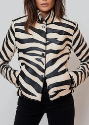 Zebra patterned jacket worn by a person on a plain background