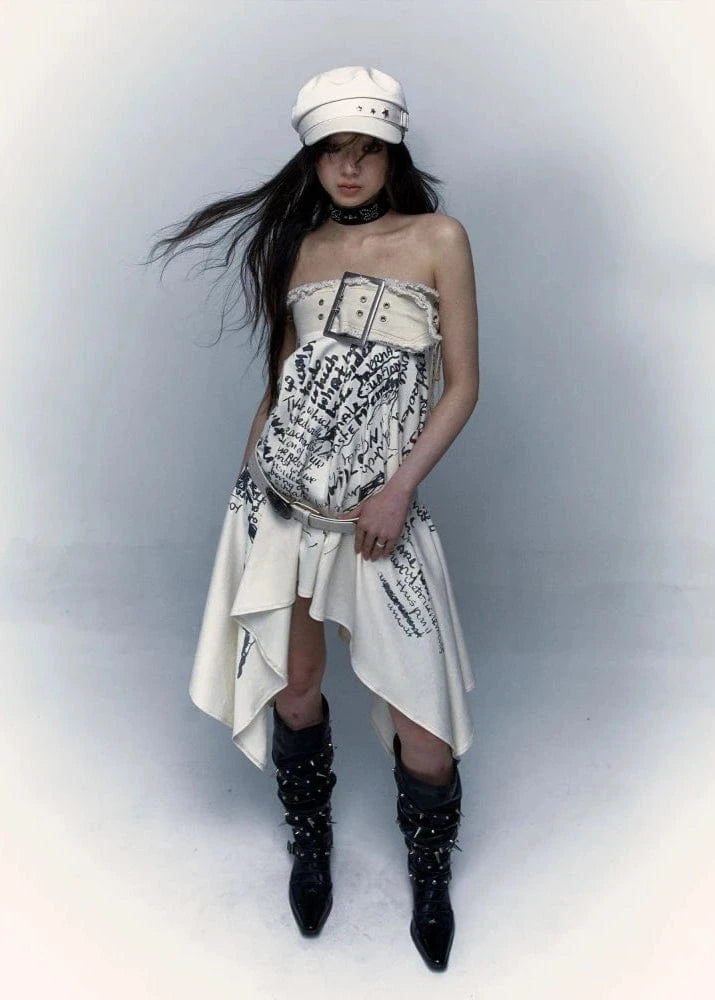 Model wearing a unique outfit with a white dress, black boots, and a white cap against a light gray background