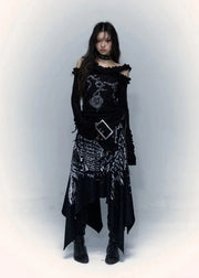 Person wearing a black, intricate outfit with a belt and gloves on a white background