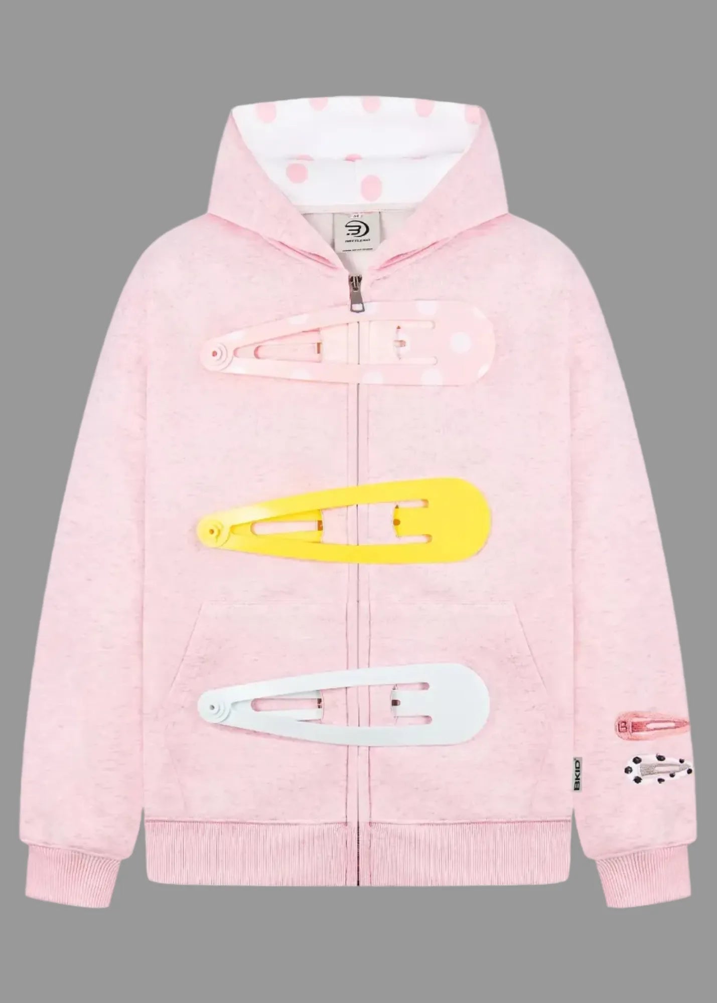 Pink hoodie with large hair clips on a white background