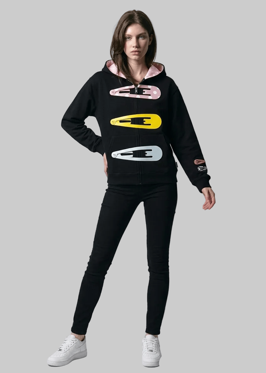 Person wearing a black hoodie with colorful designs on a gray background, featuring the brand 'arvin'.
