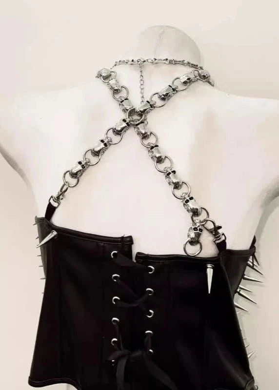 Black outfit with chain details on a mannequin against a white background