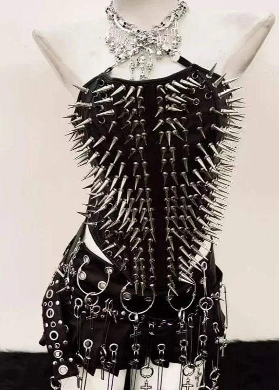 Black spiked dress on a mannequin against a white background