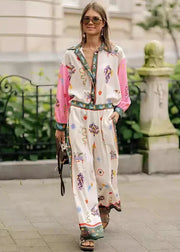 Woman wearing a colorful outfit with a floral pattern on a city street.