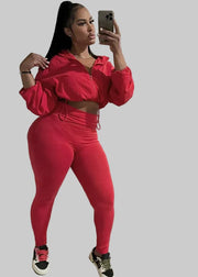 Person wearing a red outfit taking a mirror selfie in a living room.