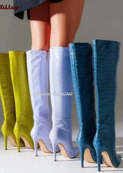 Four pairs of high-heeled knee-high boots in yellow, green, blue, and purple on a neutral background.