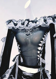 Black and white outfit with ruffled top and long sleeves on a light background