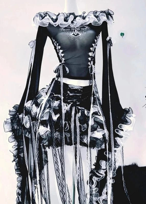 Black and white outfit with ruffled details on a plain background