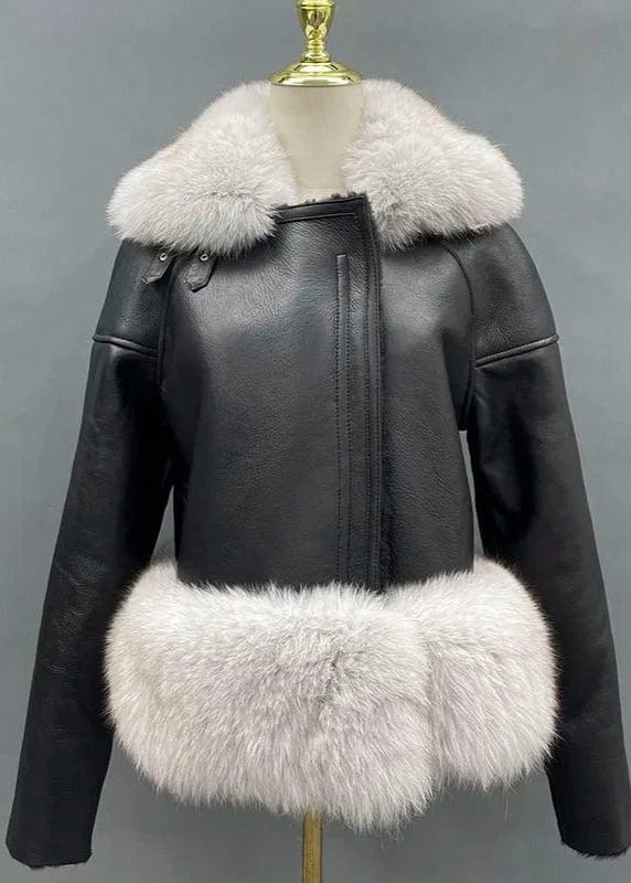Black leather jacket with white fur trim on a mannequin against a gray background