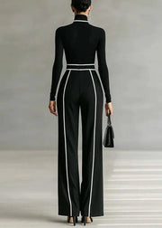 Person wearing a black jumpsuit with white stripes on a neutral background