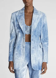 Person wearing a light blue patterned suit on a white background