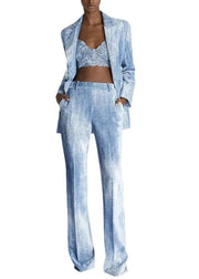 Woman wearing a light blue denim outfit with a matching jacket on a white background, featuring the brand 'TwoTwinStyle'.