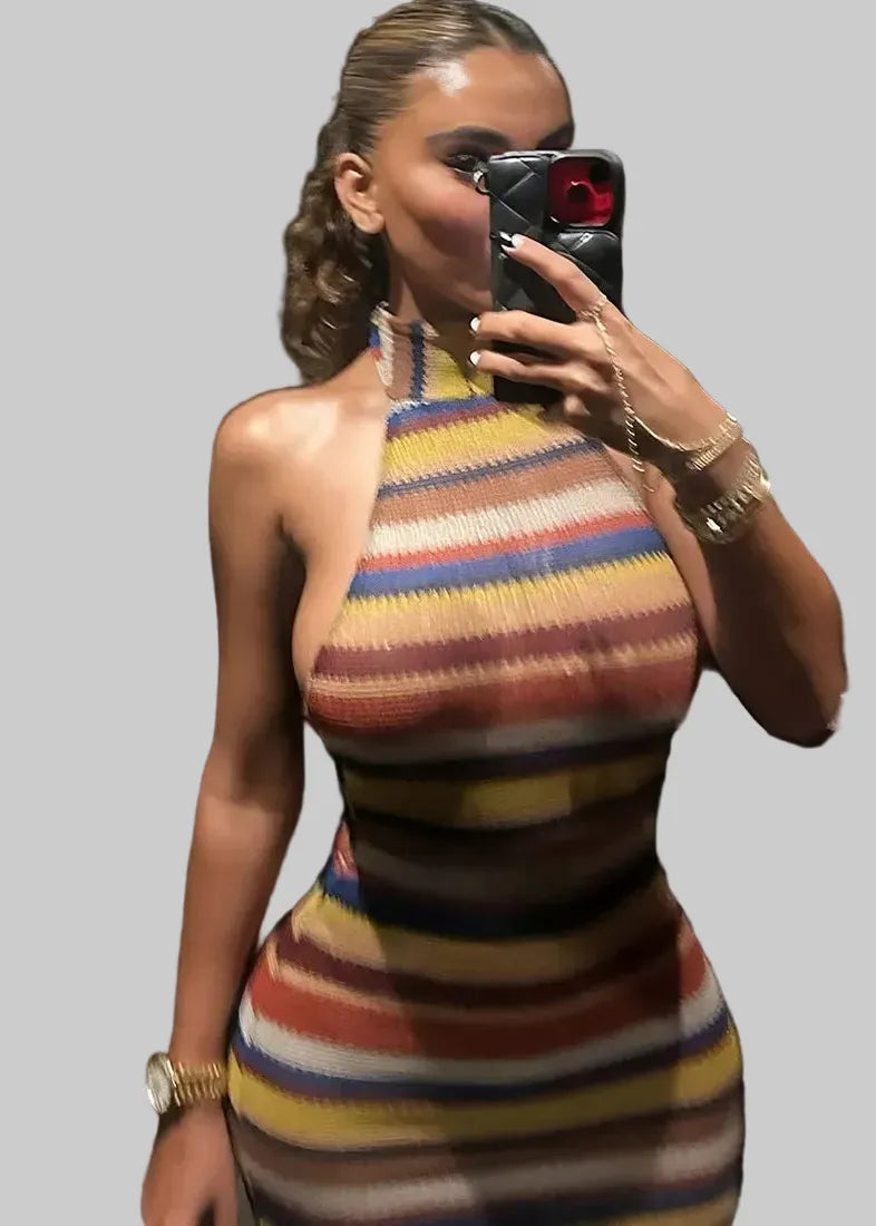 Woman taking a mirror selfie wearing a colorful striped dress.