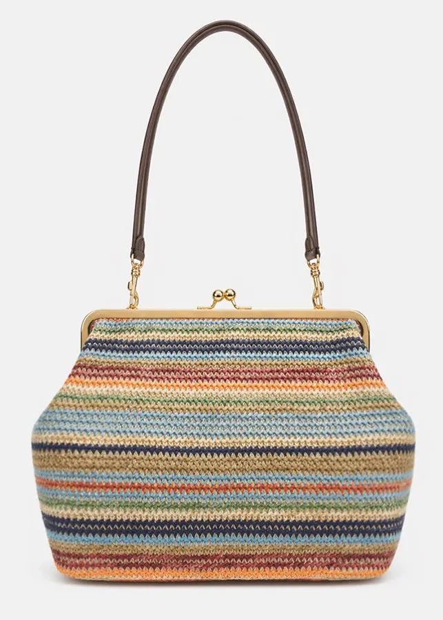 Multicolored striped handbag with a brown handle on a light gray background