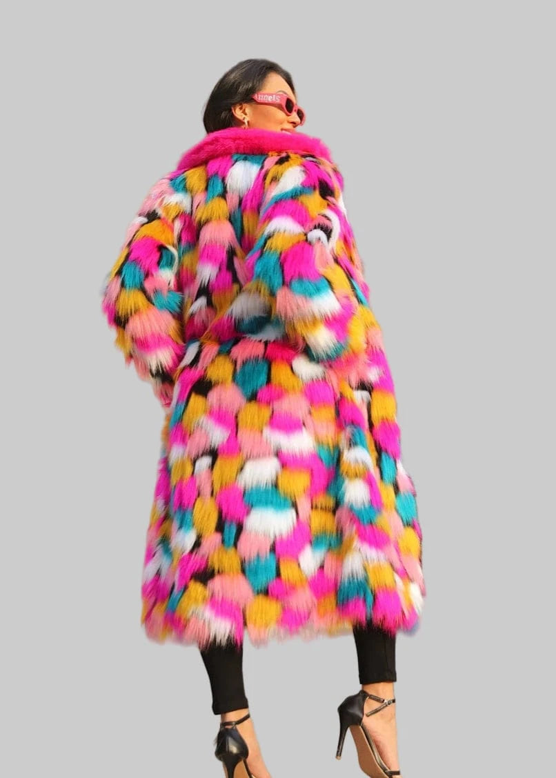 Woman wearing a colorful fur coat on a city street.