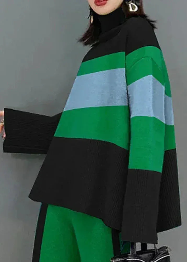 Person wearing a green and black striped sweater with a gray background