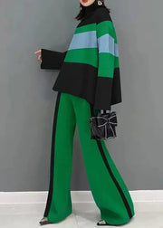 Person wearing a green and black striped outfit with a gray background