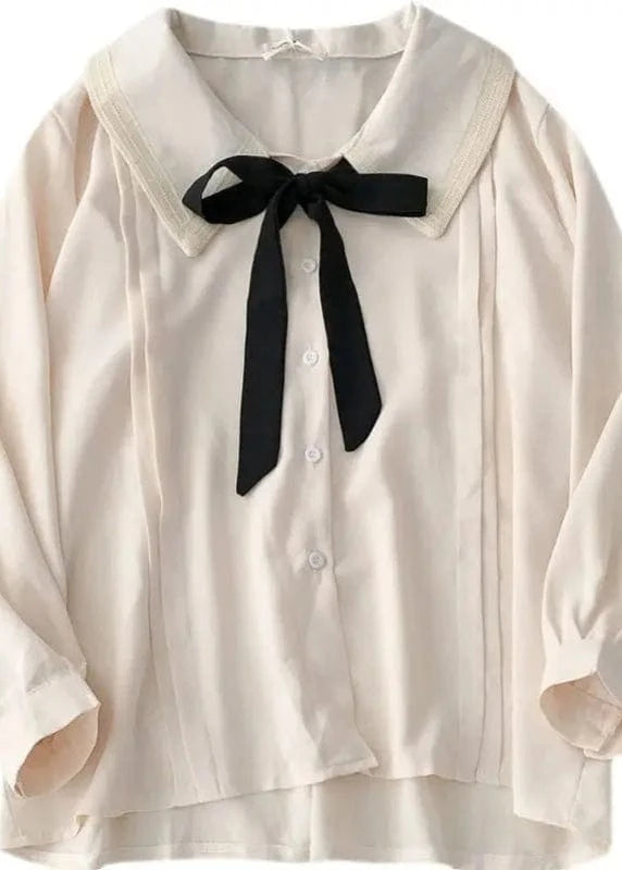 White blouse with a black bow tie on a white background