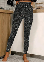 Person wearing black sequin pants in a kitchen setting
