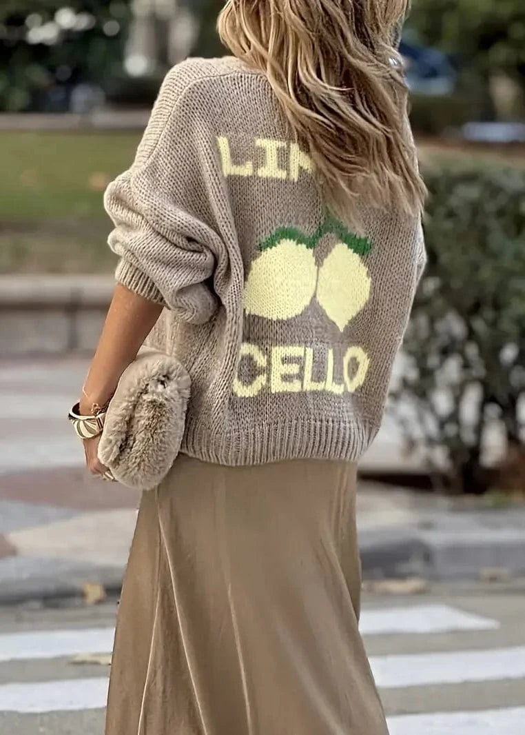 Person wearing a sweater with 'Lime Cello' design outdoors